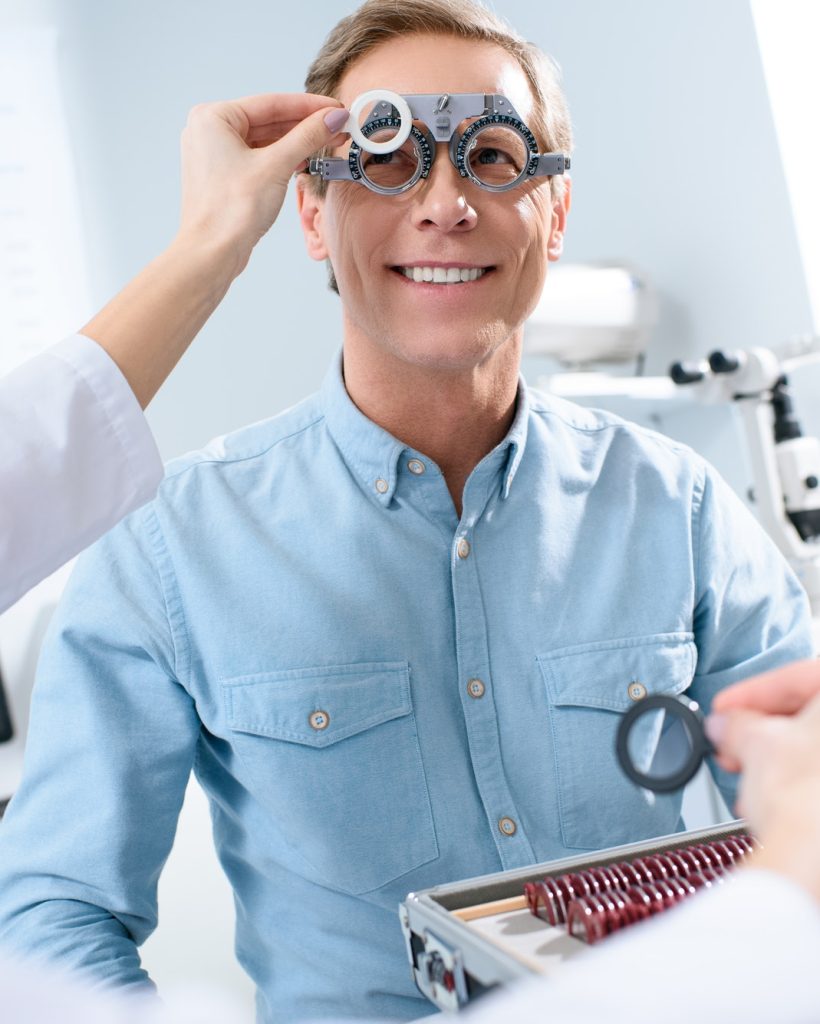 ophthalmologist-examining-middle-aged-man-eyes-with-trial-frame-and-lenses.jpg